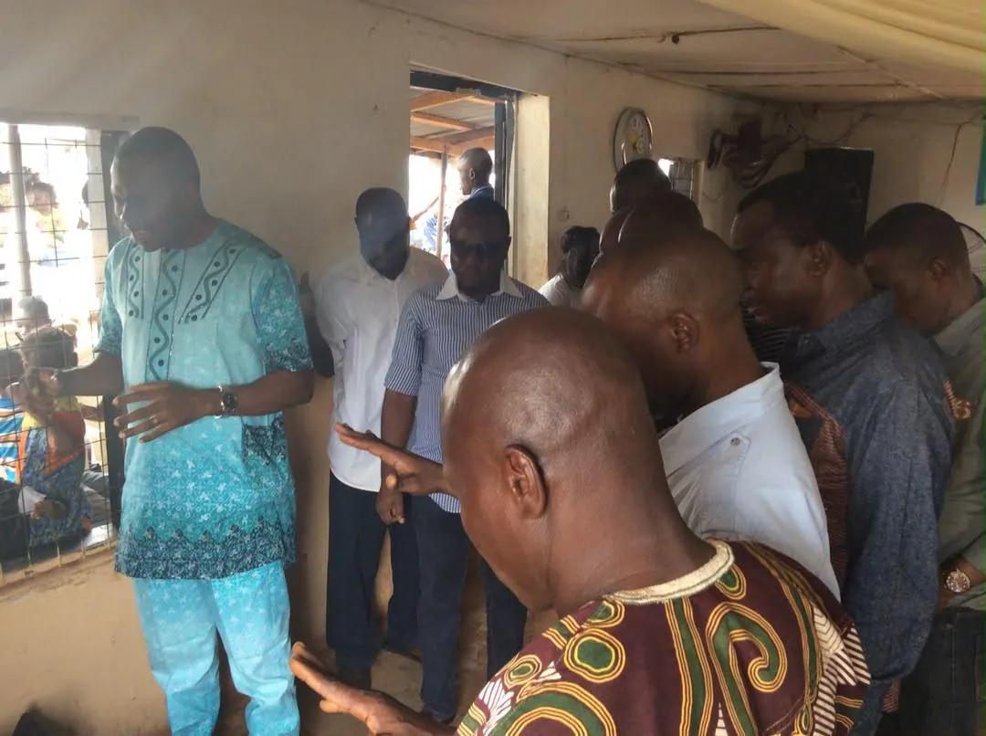 Foundation team members in discussion inside a community hall during an outreach.